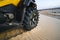 Off-road atv car closeup detail big tire, unrecognizable. ATV wheel close up. Tourist on the Quad bike rides through the