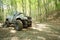 Off-road big-wheeled monster truck in mud forest