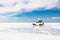 Off-road car driving through Salar de Uyuni salt flat in Bolivia