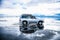 Off-road car driving through Salar de Uyuni salt flat in Bolivia