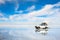 Off-road car driving on the salt flat Salar de Uyuni in Bolivia