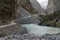 Off-road cars riding mountain serpentine in the Pamir mountains near the river