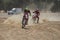 Off-road dirt bikes competing in a desert motocross rally