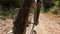 Off road front wheel point of view of a mountain bike riding on a forest path downhill