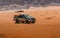 Off-road jeep going through incredible lunar landscape in Wadi Rum v