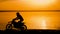 Off-road motorbike extreme cornering. Motorcyclist at sunset near the river. Extreme motocross bike, dirt from under the