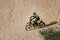 off-road motorcycle enduro motocross rider on sand dune