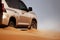 Off-road safari on the golden sands of the desert on a car in Walvis Bay. Namibia.