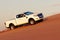 Off-road safari on the golden sands of the desert on a white car in Walvis Bay. Namibia