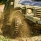 Off-road travel on mountain road. Travel concept with big 4x4 car. Mud and water splash in off-road racing. Motion and