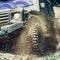 Off-road travel on mountain road. Travel concept with big 4x4 car. Mud and water splash in off-road racing. Motion and