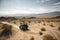 off-road vehicle disappearing into the distance, with a view of expansive desert landscape