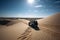 off-road vehicle driving over desert sand dunes, with clear blue skies above