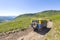 Off-road vehicle goes on the mountain gravel road way.