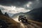 off-road vehicle speeding over mountains, with the sun shining through the clouds