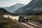 off-road vehicle speeding through scenic mountain range, with peaks in the background