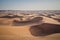 Off-road vehicles driving in the desert sand dunes of Dubai.