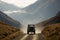 off-roader driving through misty mountain range, with tall peaks in the background