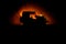 Off roader jeep silhouette on dark toned foggy sky background. Car with light at night.