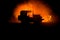 Off roader jeep silhouette on dark toned foggy sky background. Car with light at night.