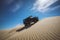 off-roader scaling daunting sand dune under clear blue sky