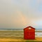 Off-season - Empty sea beach and rainbow in the sky