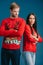 offended couple in christmas sweaters standing