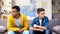 Offended multiracial teen boys sitting looking different directions, conflict