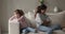 Offended sulky mom and daughter sit separately on sofa