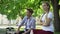 Offended teen couple sitting in park on bench, ignoring each other, conflict