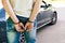 an offender standing in handcuffs near the car. Concept of arrest the driver, violation of rules and drinking alcohol while