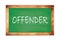 OFFENDER text written on green school board