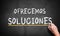 WE OFFER SOLUTIONS in Spanish concept from analyst, consultancy or advisor with a businessman writing the words in chalk