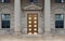 Office building with stone columns and brass colored door