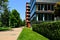 Office buildings of glass and aluminum curtain wall exterior in lush green park setting