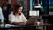 Office clerk looking through financial business documents on laptop