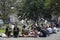 Office clerks sit on the grass and dine at Golden Square, Soho, exposing faces to the sun