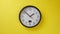 Office Clock Hanging on a Yellow Color Wall