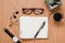 Office desk agenda with glasses in a wooden background  