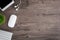 The office desk flat lay view with keyboard, mouse, tree and earphone on wood texture background