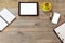 Office desk mock up template with tablet, smart phone, notebook and cup of coffee. View from above with copy space