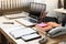 The office desk,plenty of business paper chart beisde laptop,pencil,telephone