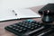 Office desk of startup businessman near the window with a laptop, books and a calculator. Business or work concept