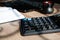 Office desk of startup businessman near the window with a laptop, books and a calculator. Business or work concept