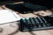 Office desk of startup businessman near the window with a laptop, books and a calculator. Business or work concept