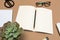 Office desk table with  notebook scissors glasses succulent and pencil. Mock up template . Top view.- Image