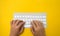 Office desk table Top view with keyboard yellow background cut