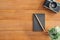 Office desk wooden table background with mock up notebooks and retro camera.