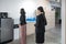 Office employee standing in queue up to drink water form water dispenser