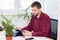 Office employee works on a tablet in a light office